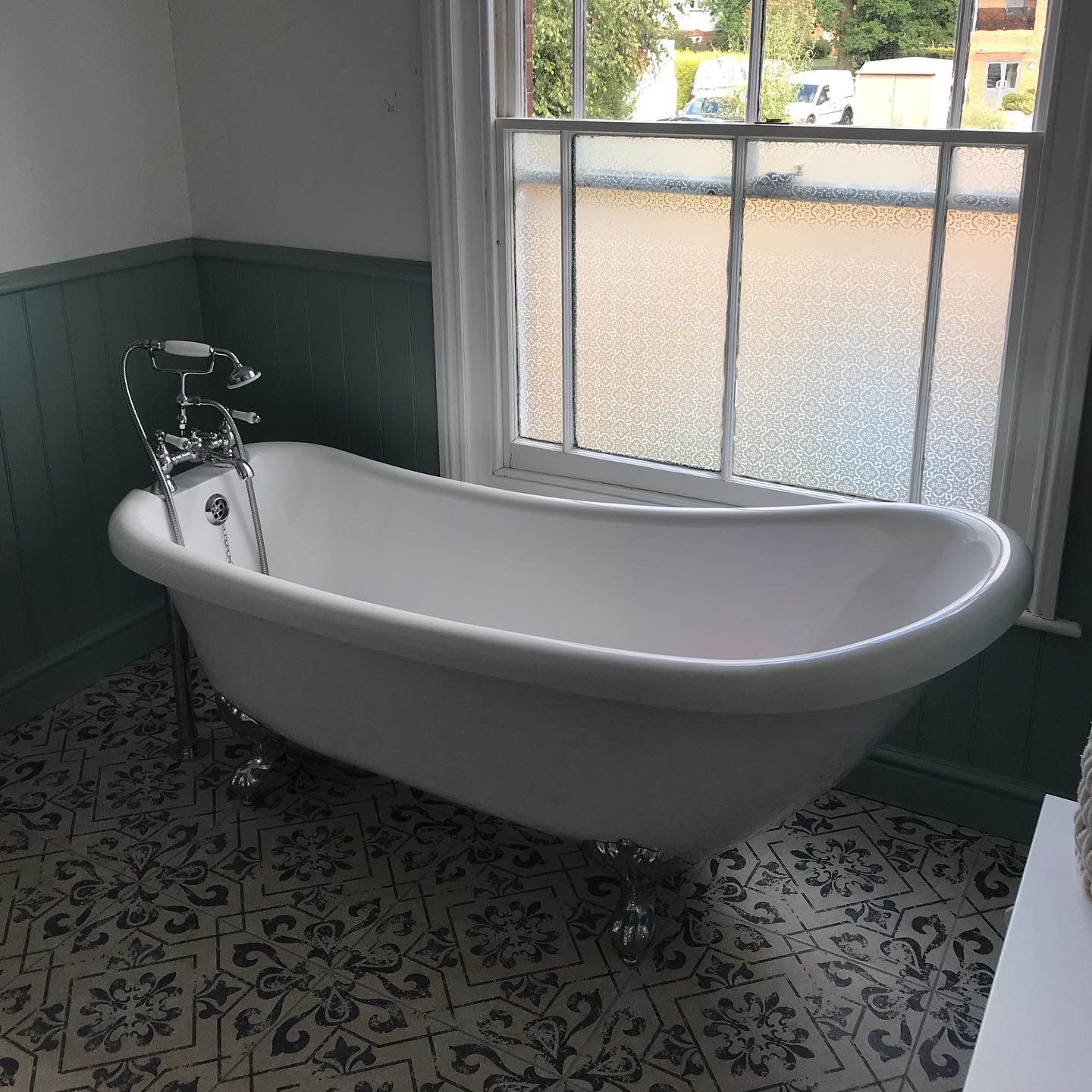 Clawfoot bath with green tongue-and-groove panelling — expert craftsmanship by LUXE Bathrooms