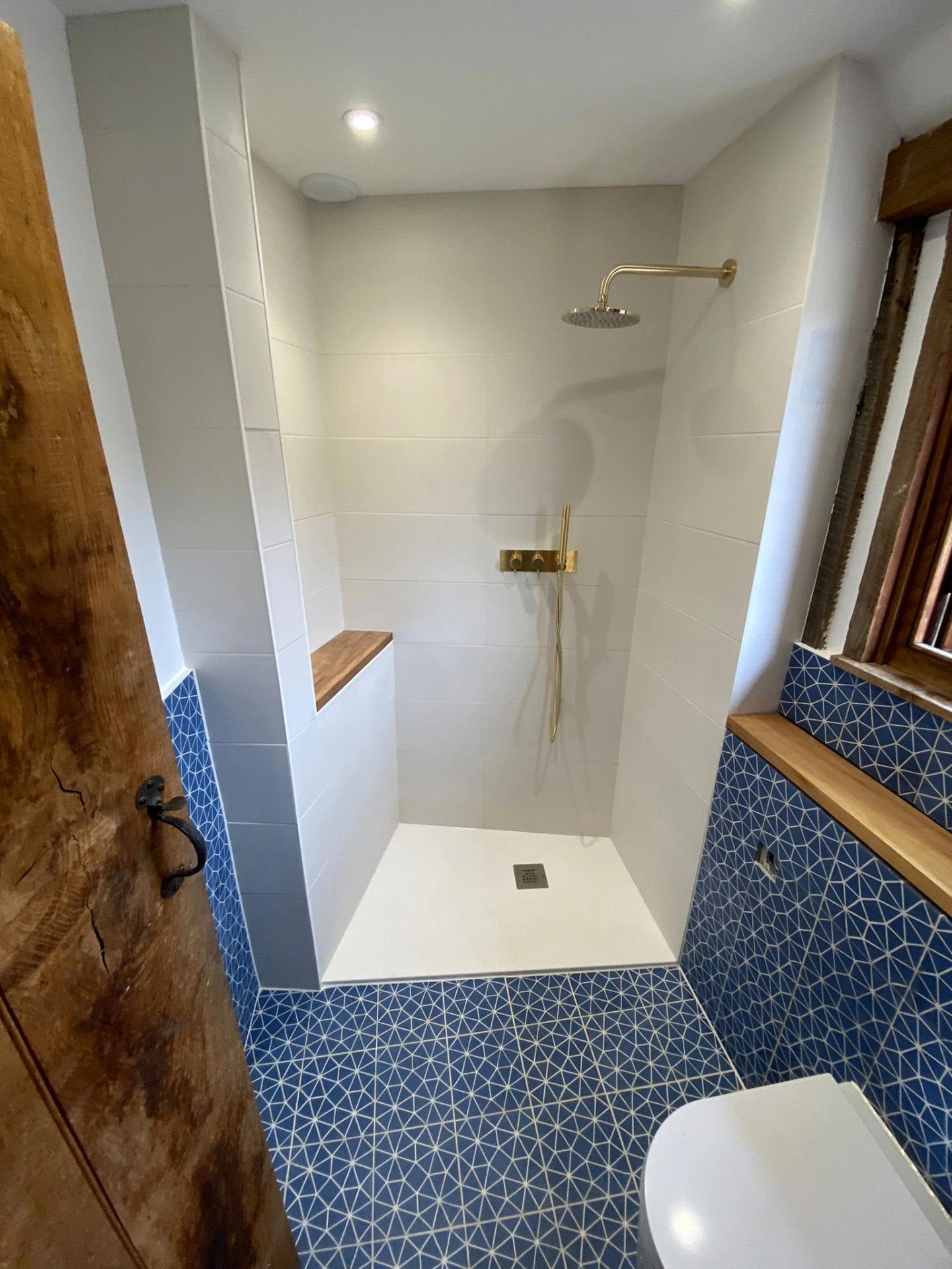 Wet room installation with level-access drainage by LUXE Bathrooms